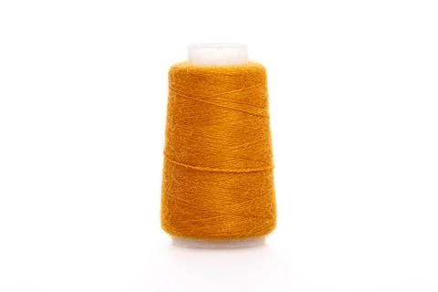 Orange spool of thread isolated on white background. Skein of woolen threads Stock Photos