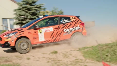 Orange sport car taking a sharp turn in slow motion Stock Footage 157374511