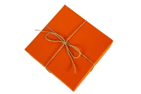 Orange square gift box tied with simple string isolated on white Stock Photos
