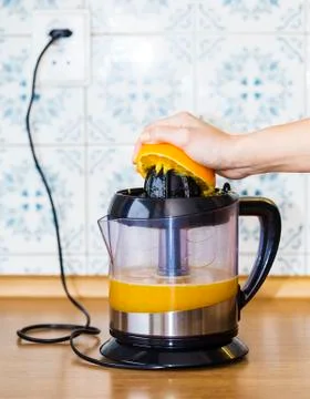 Orange squeezing Stock Photos