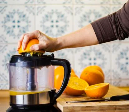 Orange squeezing Stock Photos
