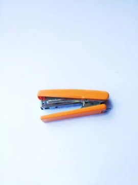 Orange stapler Stock Photos