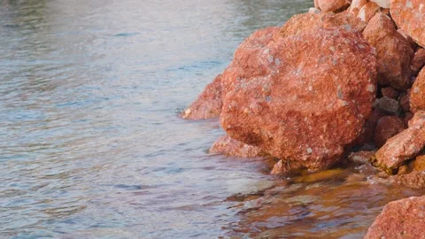Orange stone in the water Stock Footage 165175359