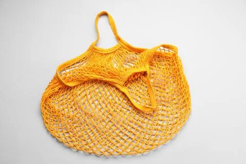 Orange string bag on light grey background, top view Stock Photos