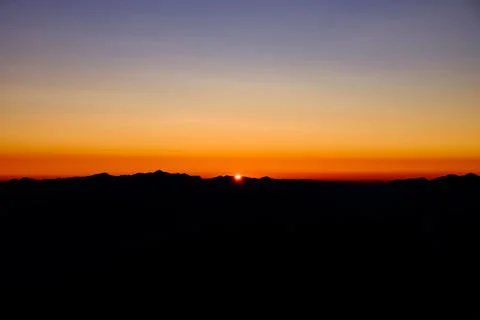 An orange sunrise in the background Stock Photos