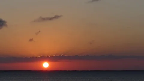 Orange sunrise, heavenly sunrays emanating thru cloud, birds Stock Footage 70031475