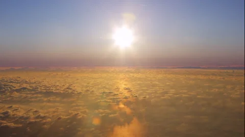 Orange sunset above the ocean with clouds below seen from an airplane Stock Footage 253752267