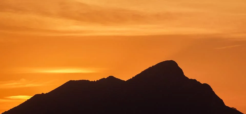 An orange sunset in the background Stock Photos