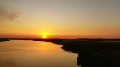 Orange sunset. Beautiful view of river under colorful sky of the setting sun. Stock Footage 135895000