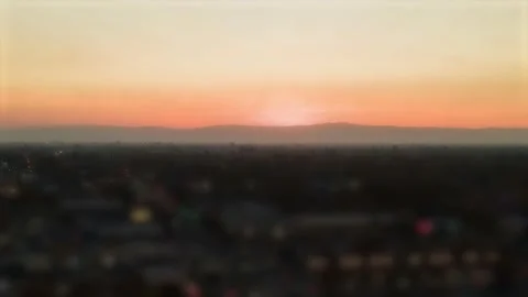 Orange Sunset behind mountains Hyperlapse tilt shift effect at Sunset Video stock 144648988