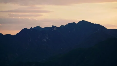 Orange sunset behind the ridge of mountains near Beijing Stock Footage 124997400