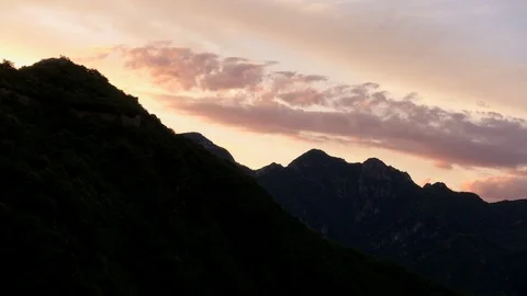 Orange sunset behind the ridge of mountains near Beijing Stock Footage 124997414