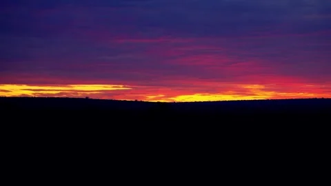 Orange sunset clouds over the darkening bush Video stock 345521051