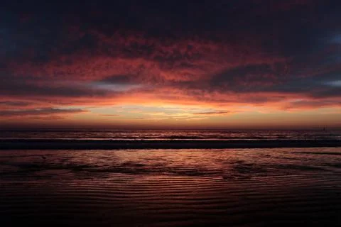 Orange sunset with clouds on the Pacific Ocean, background Stock Photos