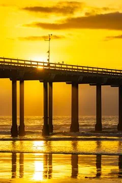 The orange sunset illuminates the pier Stock-Fotos