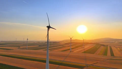 Orange sunset light on wind turbine and wheat fields, Austria Stock-Footage 348514722
