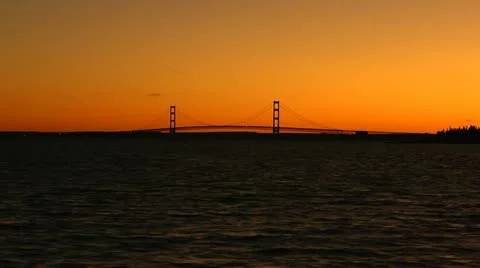 Orange sunset on Mackinac Bridge, sailing by on the ferry. Stock Footage 10831993