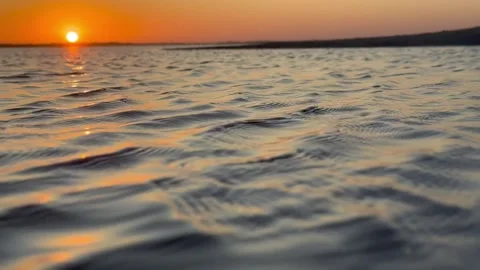 Orange sunset mini waves - close up Stock Footage 233560143