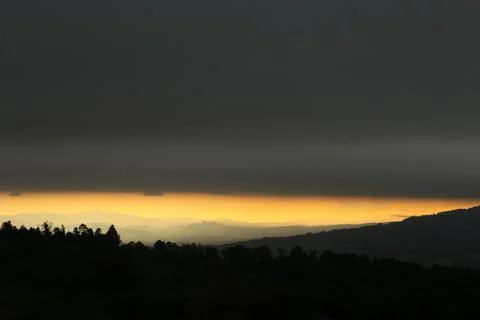 Orange sunset with the mountain range. Stock Photos