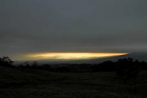 Orange sunset with the mountain range. Stock Photos
