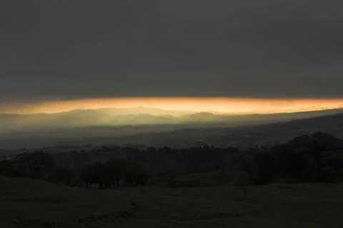 Orange sunset with the mountain range. Stock Photos