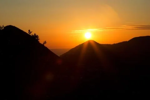 Orange sunset in the mountains Stock Photos