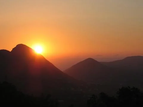 Orange sunset in the mountains Stock Photos