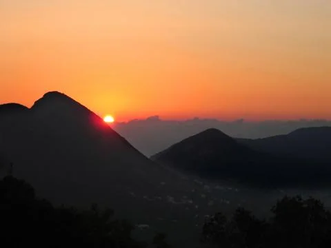 Orange sunset in the mountains Stock Photos