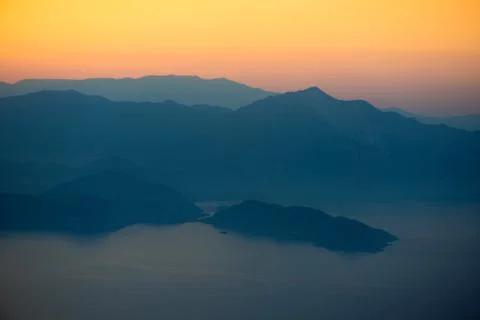 Orange sunset in the mountains. View from a height. Stock Photos