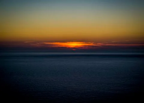 Orange Sunset over beach Stock Photos