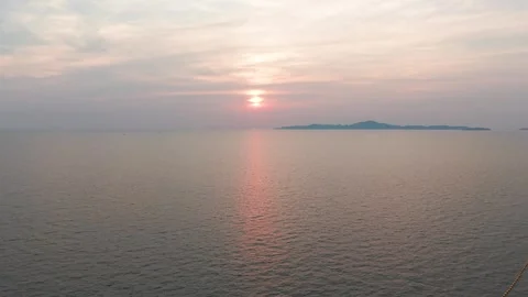 Orange sunset over calm ocean with island and buoys Vídeos de archivo 311695753