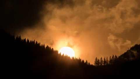 Orange sunset over dark forest silhouette Time lapse Stock Footage 89165805