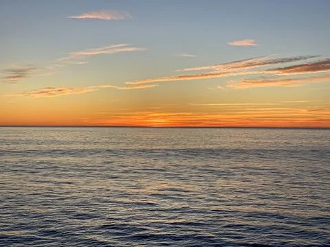 Orange sunset over the ocean Stock Photos