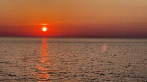 Orange sunset over the open ocean waters with copy space Stock Footage 243384308