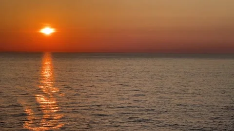 Orange sunset over the open ocean waters with copy space Stock Footage 243384756