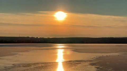 An orange sunset over a pond.  Stock Footage 239599969