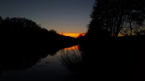Orange sunset over the river. The river in the setting sun. Evening. Stock Footage 233117464