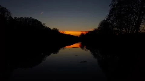 Orange sunset over the river. The river in the setting sun. Evening. Stock Footage 233117476