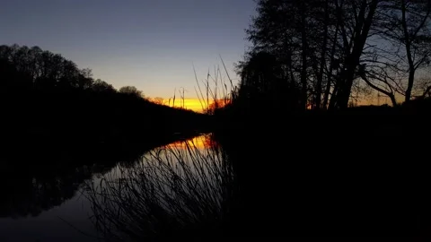 Orange sunset over the river. The river in the setting sun. Evening. Stock Footage 233117500