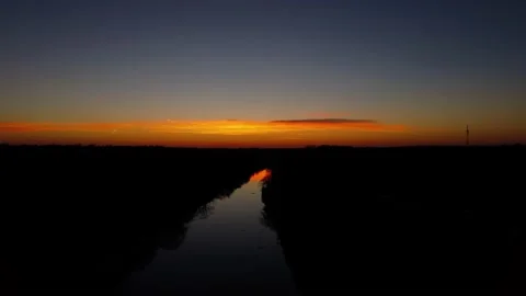 Orange sunset over the river. The river in the setting sun. Evening. Stock Footage 233117543
