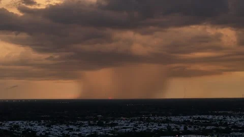 Orange Sunset Peaking through a large rain storm Aerial View Stock Footage 296238304