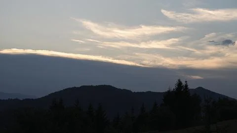 Orange sunset with the setting sun behind the mountains 스톡 사진
