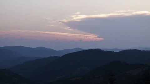 Orange sunset with the setting sun behind the mountains Stock Photos