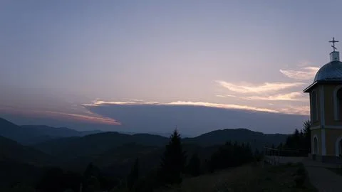 Orange sunset with the setting sun behind the mountains Stock Photos