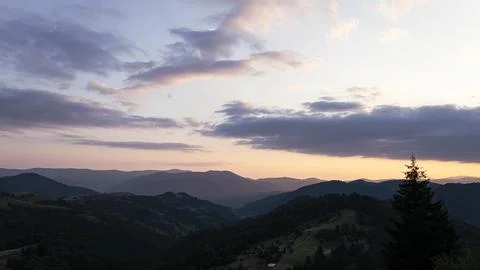 Orange sunset with the setting sun behind the mountains Stock Photos