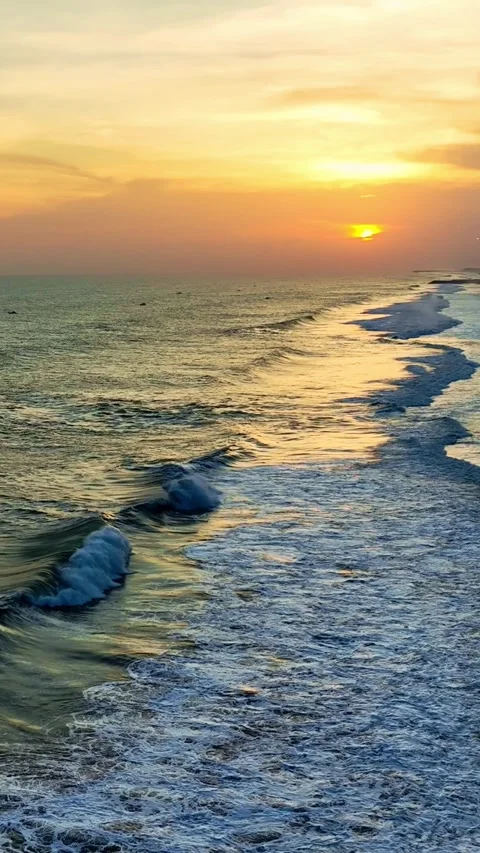 Orange sunset shining over breaking beach waves Vídeo Stock 335432832