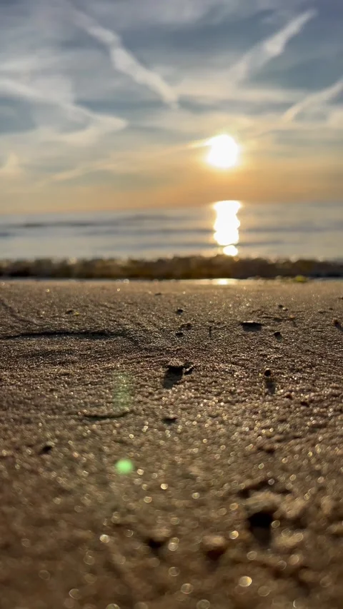 Orange sunset sky with clouds against the backdrop of ocean waves and the coast. Stock-Footage 280237941