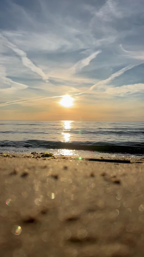 Orange sunset sky with clouds against the backdrop of ocean waves and the coast. Stock-Footage 280237957