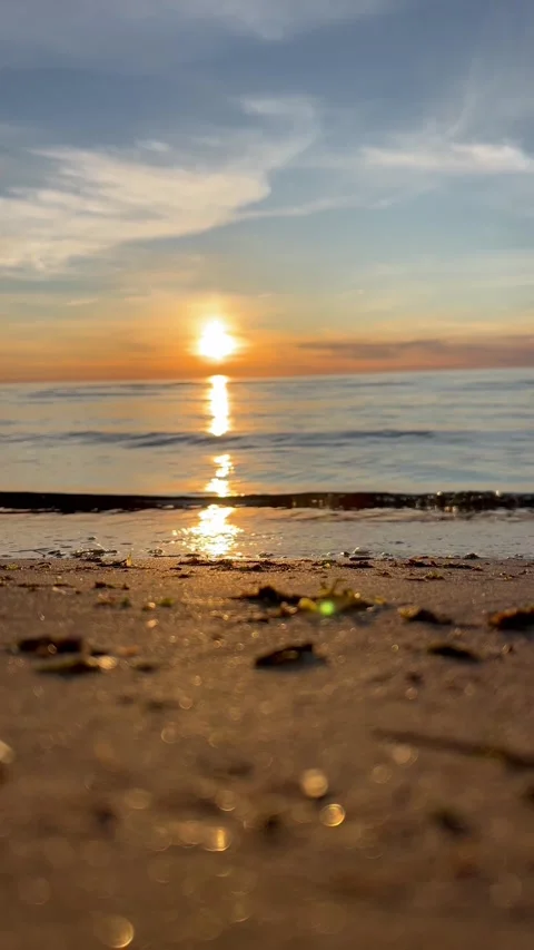 Orange sunset sky with clouds against the backdrop of ocean waves and the coast. Stock-Footage 280237965