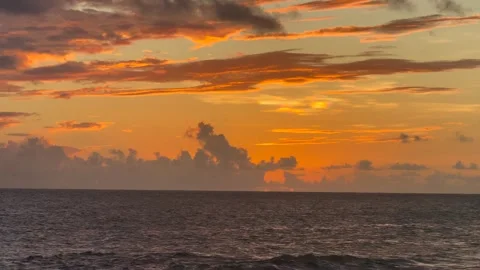 Orange sunset sky with clouds, panning down from sky view to sky and ocean view Stock Footage 321407041